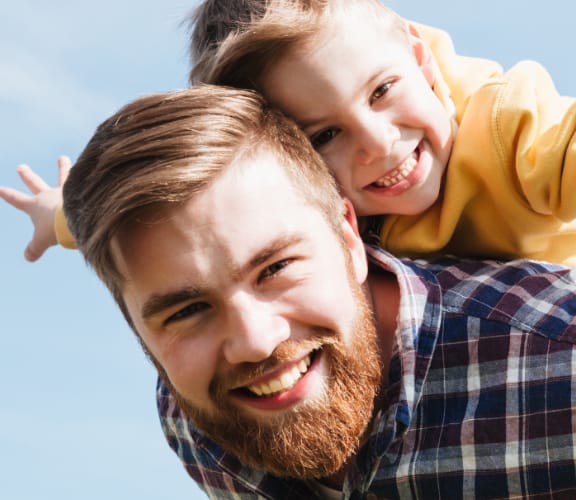 Father carrying his son on his back